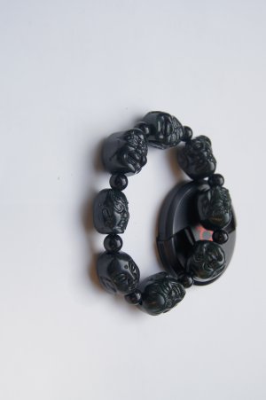 Hand-carved black jade Buddha Lohan head, rubber band string bracelet. Successful men's favorite