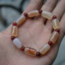 Natural red and white (agate).Hand-carved, nine cylindrical beads.Bracelet. Natural red and white (agate).Hand-carved, nine cylindrical beads.Bracelet.