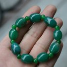 Dark green (agate), hand-carved, drum-shaped beads (bracelets). The rubber band strung together.