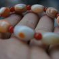 Natural wrapping (agate), hand-carved, drum-shaped beads (bracelets). Rubber band strung