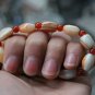 Natural wrapping (agate), hand-carved, drum-shaped beads (bracelets). Rubber band strung