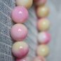 Peach jade bracelets, carved, about 13 mm beads, rubber bands strung together.