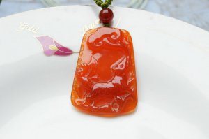 Hand-carved natural red agate dogs. Pendant necklace.