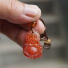 Natural (carnelian) pendants, amulets.Hand-carved laughing Buddha. Necklace pendant. Natural (carnelian) pendants, amulets.Hand-carved laughing Buddha. Necklace pendant.
