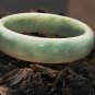 Natural light green jade bracelet. An inner diameter of 59 mm, 16 mm, a width of 9 mm thick.