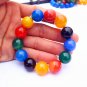 Natural red blue black green agate bead, 15.7 mm 13 beads. Rubber bands form an attractive bracelet.