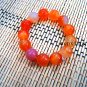 Natural red agate beads. The single bead is about 16 mm in diameter and forms a bracelet.