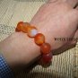 Natural red agate beads. The single bead is about 16 mm in diameter and forms a bracelet.