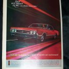 Vintage 1965 OLDSMOBILE Olds Red Rocket Action Print Ad
