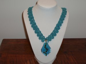 Neck lace crocheted blue glass pendant