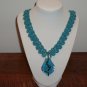 Neck lace crocheted blue glass pendant