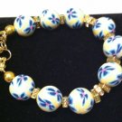 Yellow polymer clay w a light & dark blue floral bracelet