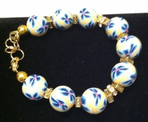 Yellow polymer clay w a light & dark blue floral bracelet
