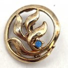 Gold Tone Almost Round with a Blue Stone and Leaf In Center Pin/Brooch (J1) Gold Tone Almost Round with a Blue Stone and Leaf In Center Pin/Brooch (J1)