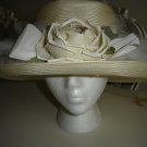 ENCHANTING OFF WHITE MESH HAT WRAPPED IN TULLE WITH A STRIKING BEIGE SILK FLOWER!