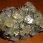 Shiny pyrite fossil mineral specimen with big gem crystals of clear calcite
