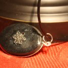 Black Oval with Flower