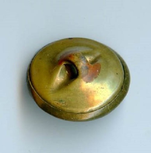 Antique brass button with sunrise scene