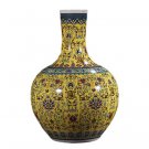 Yellow enamel celestial sphere shaped ceramic vase on the ground