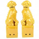 A pair of bright yellow sculpture ceramic poodles for living room