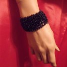 Beaded stretch with a buttoned closure