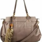 attractive brown patent leather with fox tail embellished handbag