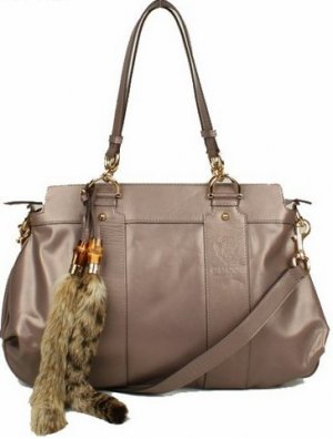 attractive brown patent leather with fox tail embellished handbag