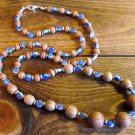 Item 103- 29" porcelain, graduated wood and brass necklace.