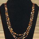 Item 72- 22" Three strand tiger eye, grossularite, glass & silverplate necklace.