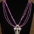 Item 112: 19" glass and rhinestone necklace with silvertone cross pendant