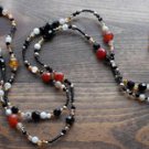 Item 29- 54" Agate, antique glass and brass necklace.