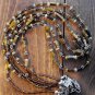 Item 72- 22" Three strand tiger eye, grossularite, glass & silverplate necklace.