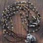 Item 72- 22" Three strand tiger eye, grossularite, glass & silverplate necklace.