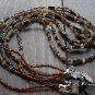 Item 72- 22" Three strand tiger eye, grossularite, glass & silverplate necklace.