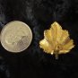 BSK Signed Gold tone vintage earrings maple leaf Canada textured clip on