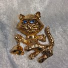 Cat blue rhinestone eyes goldton bell moves vintage Pin Brooch Avon 1974