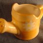 6 1/2" x 3 1/2" CERAMIC, PEACH COLORED DECORATIVE WATERING CAN WITH PAINTED WHITE DAISIES