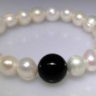 White Freshwater pearl bracelet with a Black Onyx focal bead