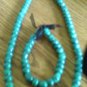 Teal necklace and bracelet set with black ribbon.
