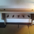 Light wood wall mounted shelf with 5 pegs