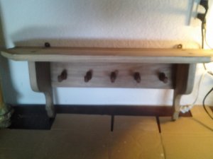 Light wood wall mounted shelf with 5 pegs