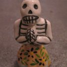 Ceramic Day of the Dead Figure, Woman in Tan Skirt with Dark Blue Flower Design Ceramic Day of the Dead Figure, Woman in Tan Skirt with Dark Blue Flower Design