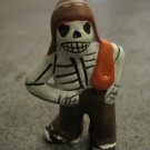 Ceramic Day of the Dead Figure, Man with Pants, Hat, and Blanket Ceramic Day of the Dead Figure, Man with Pants, Hat, and Blanket