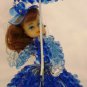 VINTAGE BLUE ROSETTE BEADS DOLL WITH UMBRELLA