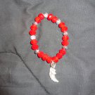 Beautiful, shiny red bracelet with silver charm