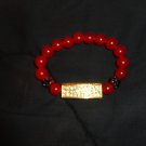 Red bead bracelet with gold bling charm to make a statement