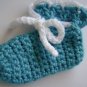 Blue crochet baby shoes with white finish and cord.