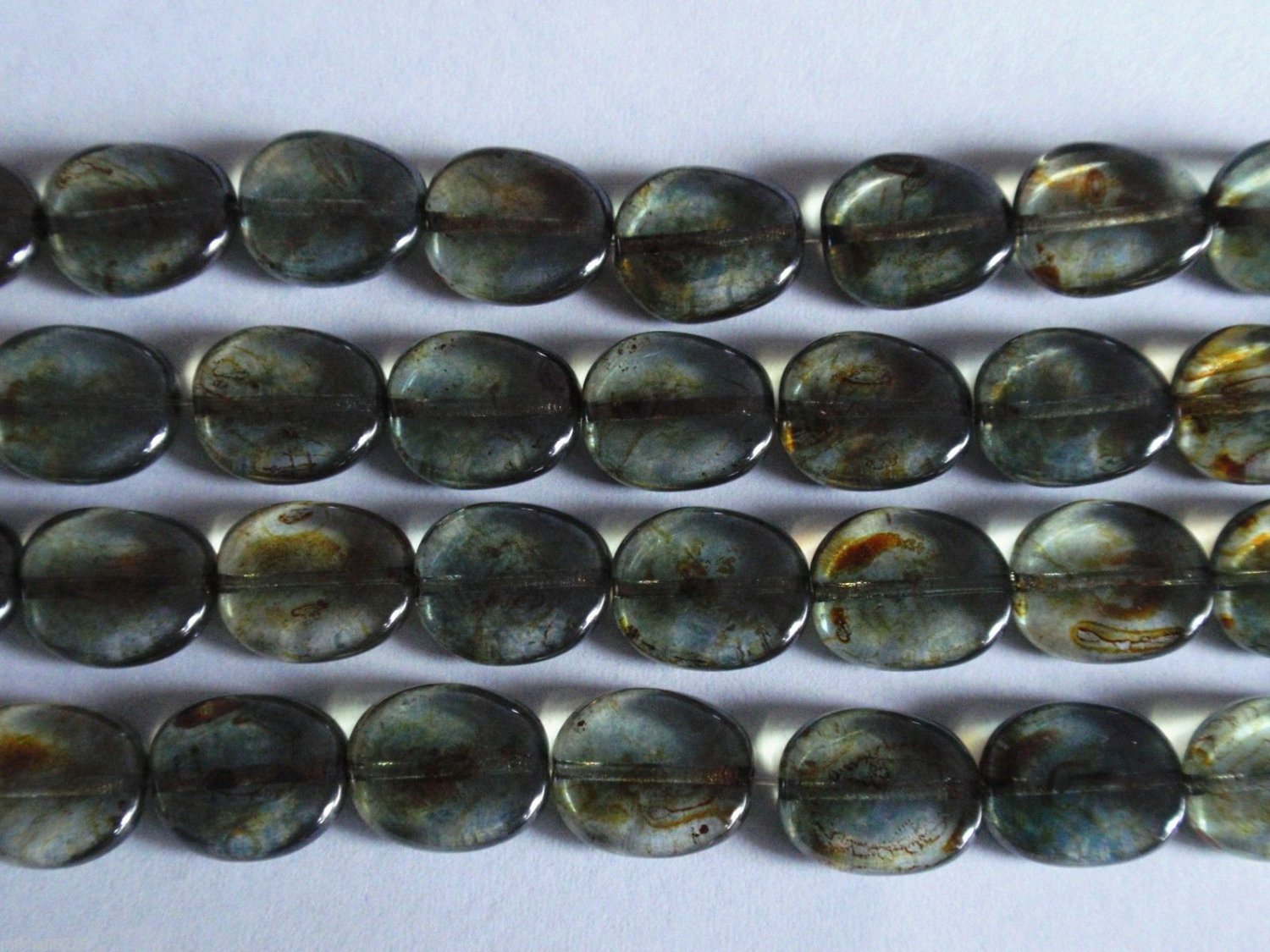 25 12 x 9 mm Twisted Flat Oval Beads: Luster - Transparent Green