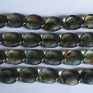 25 12 x 9 mm Twisted Flat Oval Beads: Luster - Transparent Green
