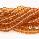 25 7 x 9 mm Czech Glass Druk Roller Beads: Topaz